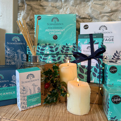 Collection of candles and boxes on a wooden surface with a stone wall background